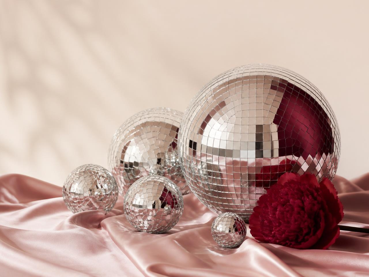 Disco balls arranged on blush satin